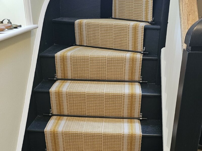 Golden tones in a narrow runner with Plain Iron Stair Rods